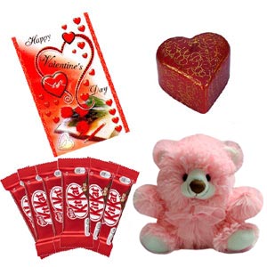 Teddy bear with chocolate, candle and card