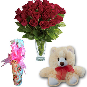 Roses in vase with bear and bottle message